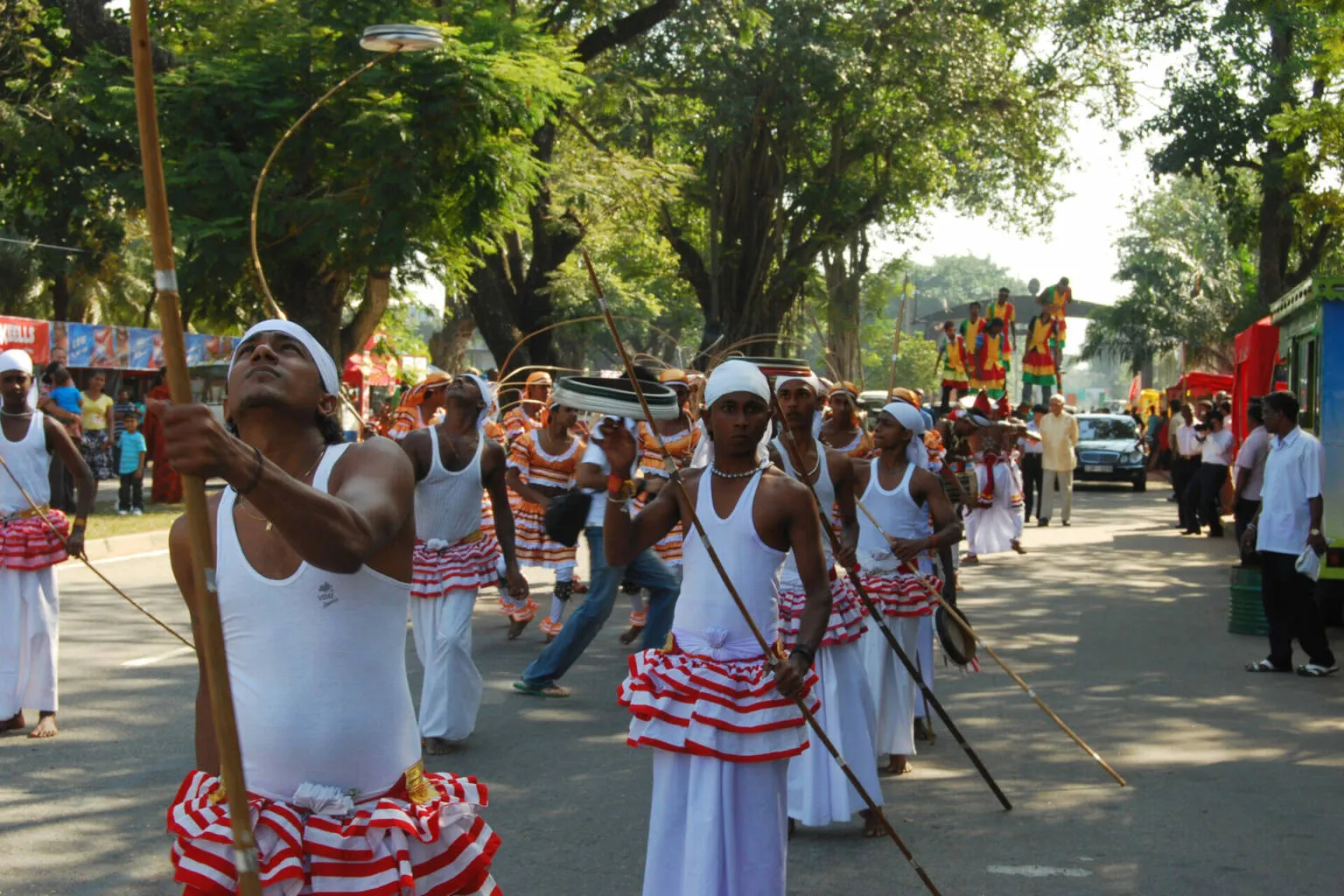 A group of men dressed in white and red outfits, standing together in a unified display of color and camaraderie.