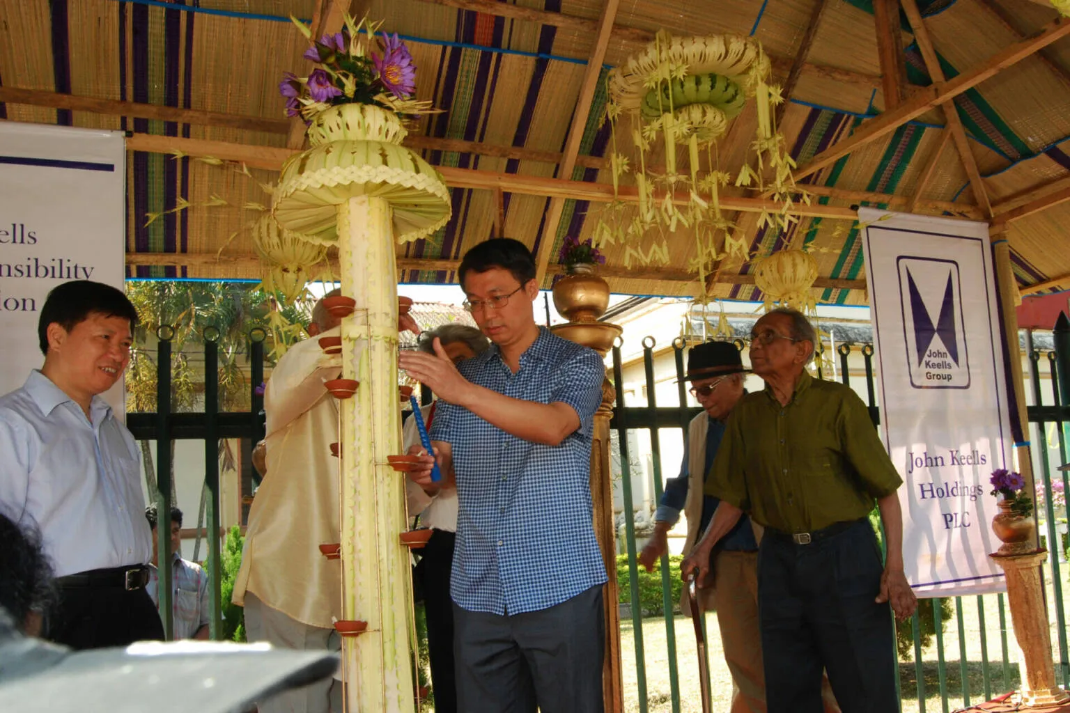 A man is seen pruning a colorful flower, demonstrating his dedication to maintaining.